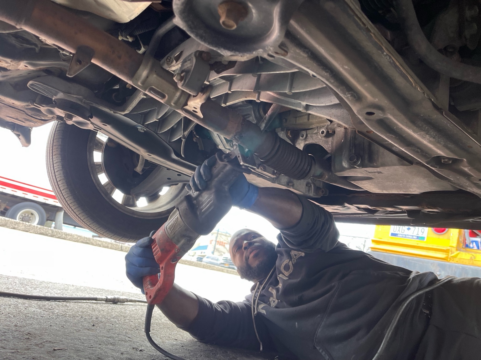 Technician working underneath a vehicle